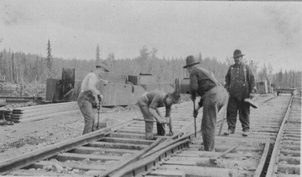 Men work on steel railroad tracks near Nome, Alaska, around 1900. (Carpenter Collection, Library of Congress)