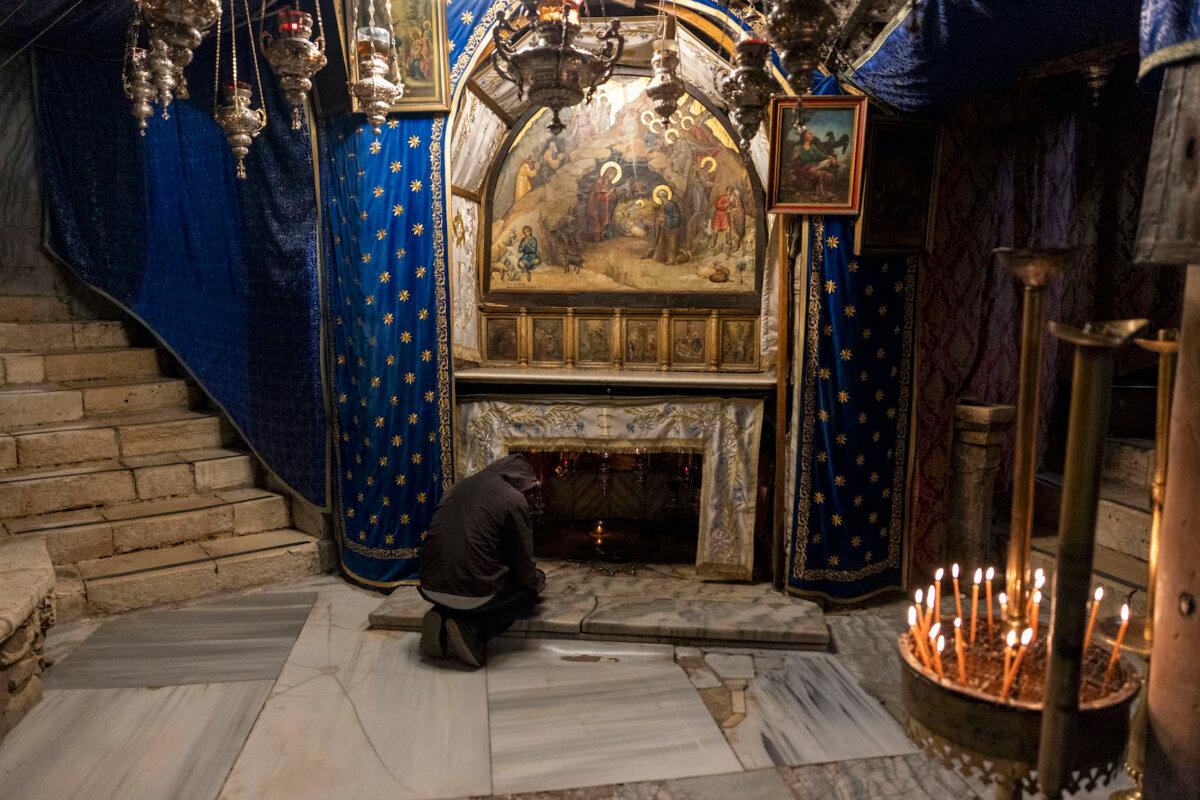 A worshipper prays in the grotto, believed to be the spot where Jesus was born, at the Church of Nativity in Bethlehem, West Bank on Dec.17, 2023. (Maja Hitij/Getty Images)