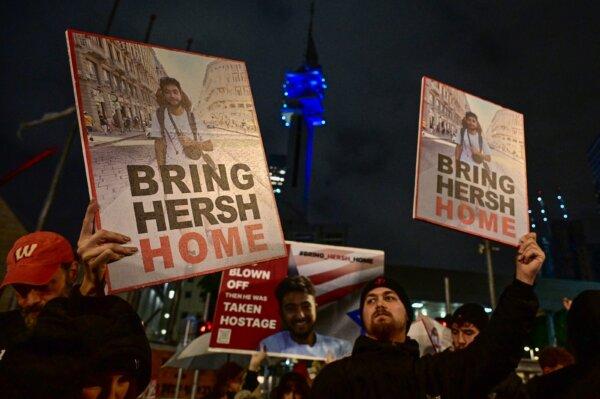 Protesters lift placards during a rally for supporters and relatives of Israeli hostages held in Gaza since the Oct. 7, 2023, attack, in Tel Aviv, Israel, on Dec. 23, 2023. (Alberto Pizzoli/AFP via Getty Images)