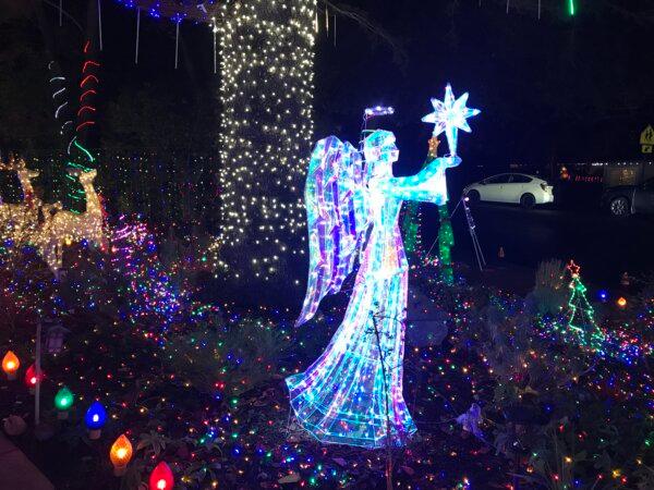 A glowing angel statue at the home of Terri Perez, “The Christmas Lights Lady,” in Danville, Calif., on Dec. 19, 2023. (Helen Billings/The Epoch Times)