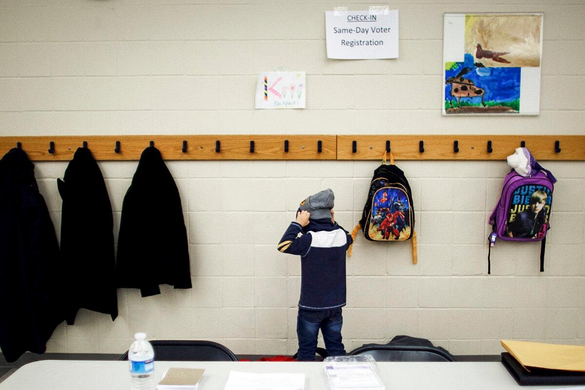 A boy prepares to leave school before the arrival of Caucus voters at Walnut Hills Elementary School in January 2012 in Urbandale, Iowa. (Jonathan Gibby/Getty Images)