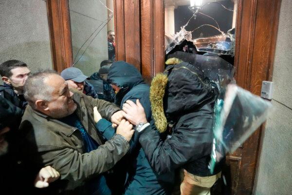 Protesters attempt to enter the capital's city council building in Belgrade, Serbia, on Dec. 24, 2023. (Darko Vojinovic/AP)