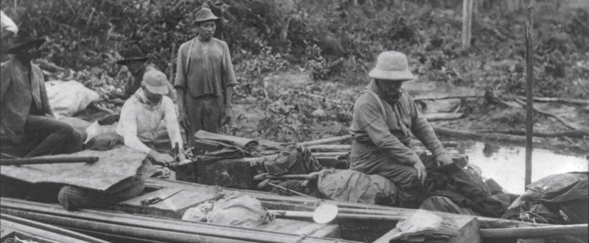 Roosevelt sits in a dugout canoe, photographed by Kermit Roosevelt, 1913. (Public Domain)