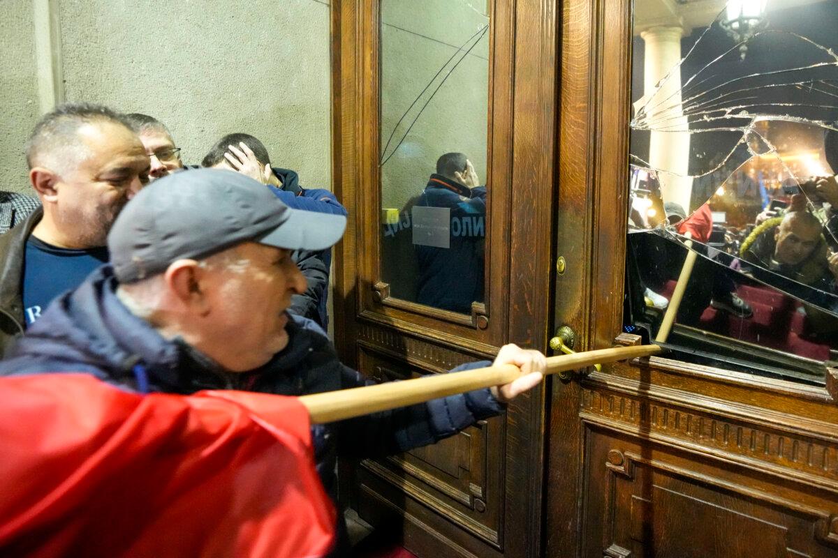 Opposition supporters attempt to enter the capital's city council building in protest of what election observers said were widespread vote irregularities during a general election last weekend in Belgrade, Serbia, on Dec. 24, 2023. (Darko Vojinovic/AP Photo)