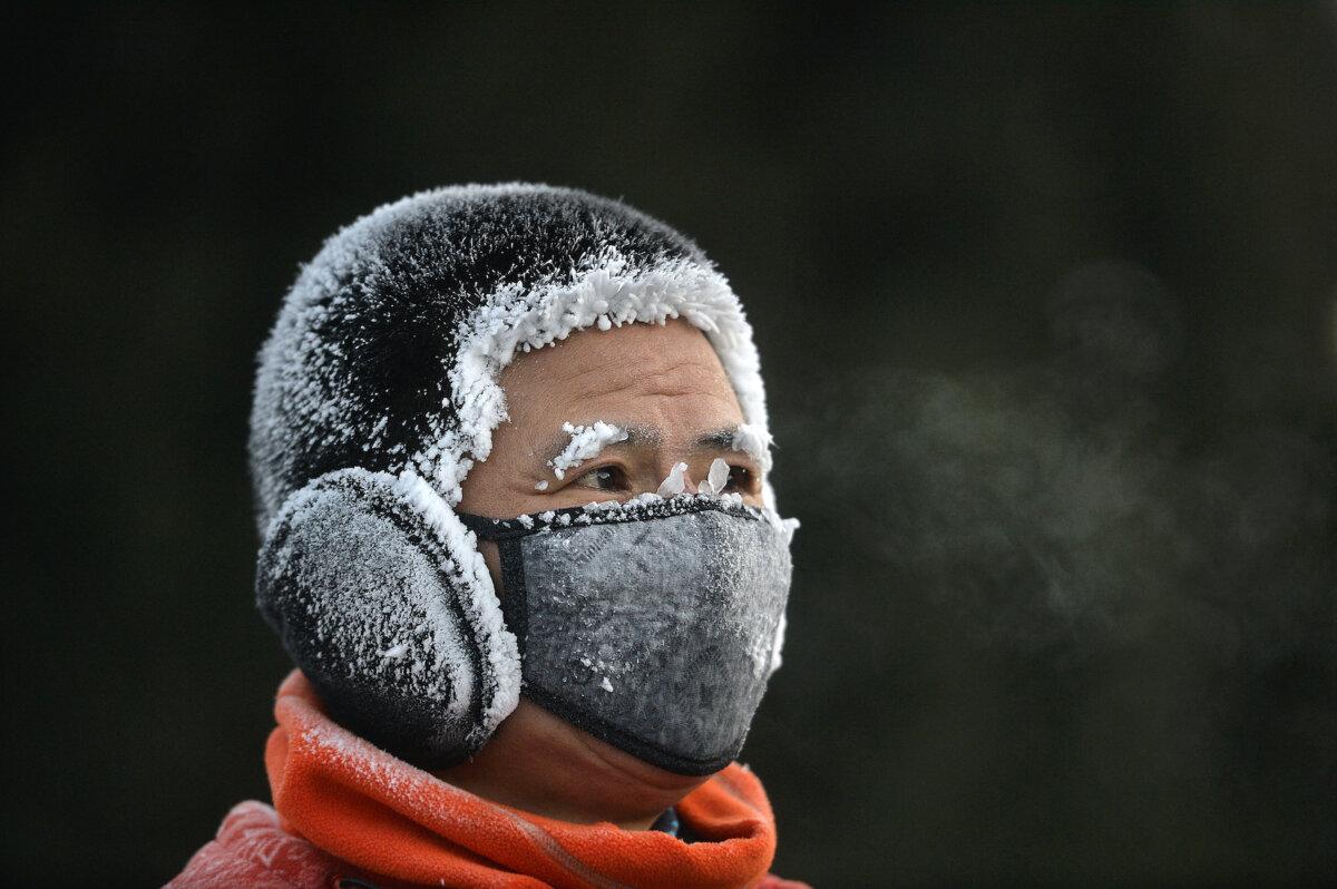 A resident is covered in frost during cold weather in Shenyang, in China's northeast Liaoning province on Dec. 20, 2023. (STR/AFP via Getty Images)