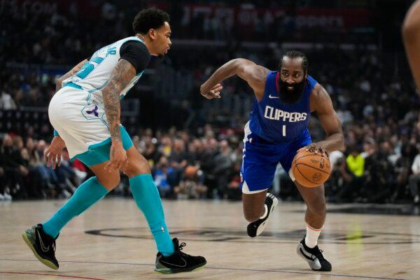 Charlotte Hornets forward P.J. Washington (25) defends against Los Angeles Clippers guard James Harden (1) during the first half of an NBA basketball game in Los Angeles on Dec. 26, 2023. (Ashley Landis/AP Photo)