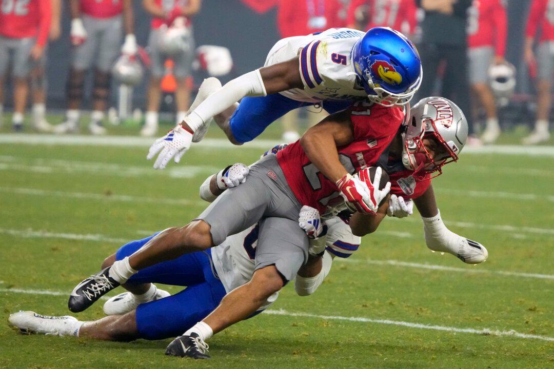 Bean Throws for 6 TDs, Kansas Overcomes Flags to Beat UNLV 49–36 in Guaranteed Rate Bowl