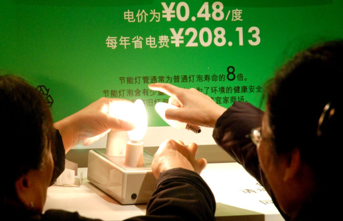 Shoppers in Beijing test energy-saving light bulbs at a home store, on Dec. 7, 2009. (Wang Zhao/AFP via Getty Images)