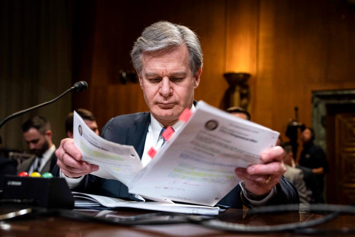 FBI Director Christopher Wray looks over notes as he arrives for a Senate Appropriations Subcommittee on Commerce, Justice, Science, and Related Agencies hearing on Capitol Hill in Washington on May 10, 2023. (Drew Angerer/Getty Images)