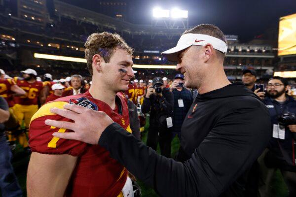 Head coach Lincoln Riley congratulates Miller Moss (7) of the USC Trojans after defeating the Louisville Cardinals in the Holiday Bowl in San Diego on Dec. 27, 2023. (Sean M. Haffey/Getty Images)