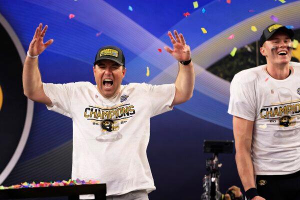 Head coach Eliah Drinkwitz and Brady Cook (12) of the Missouri Tigers celebrate after defeating the Ohio State Buckeyes in the Goodyear Cotton Bowl in Arlington, Texas, on Dec. 29, 2023. (Ron Jenkins/Getty Images)