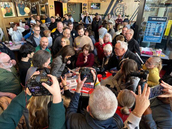Former South Carolina Gov. Nikki Haley signs campaign materials at a campaign event in Coralville, Iowa, on Dec. 30, 2023. (Austin Alonzo/The Epoch Times)