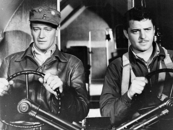 Capt. Jim “Pappy” Gordon (John Wayne, L) and his old friend, hotshot aviator Woody Jason (John Carroll), in “Flying Tigers.” (Republic Pictures)