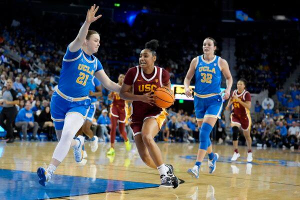 Southern California guard JuJu Watkins (C) drives to the basket as UCLA forward Lina Sontag (21) defends during the first half of an NCAA college basketball game in Los Angeles on Dec. 30, 2023. (Marcio Jose Sanchez/AP Photo)