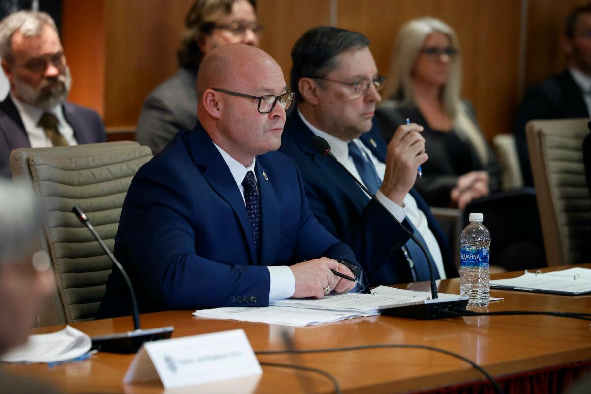 International Brotherhood of Teamsters General President Sean O’Brien (L) and General Secretary-Treasurer Fred Zuckerman listen to Republican presidential candidate and former U.S. President Donald Trump during a meeting at the union's headquarters in Washington on Jan. 31, 2024. (Chip Somodevilla/Getty Images)