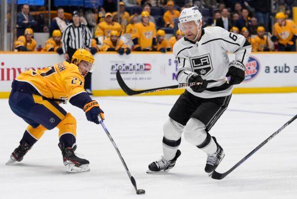 Nashville Predators defenseman Ryan McDonagh (27) hits the puck away from Los Angeles Kings center Trevor Lewis (61) during the first period of an NHL hockey game in Nashville on Jan. 31, 2024. (George Walker IV/AP Photo)