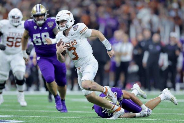 Quinn Ewers (3) of the Texas Longhorns runs with the ball during the second quarter against the Washington Huskies during the CFP Semifinal Allstate Sugar Bowl at Caesars Superdome in New Orleans on Jan. 1, 2024. (Jonathan Bachman/Getty Images)