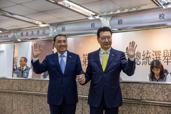 KMT presidential candidate Hou Yu-ih (L), and his vice presidential running mate, Jaw Shaw-kong, wave to journalists before registering their candidacy for the presidential election in Taipei, Taiwan, on Nov. 24, 2023. (Annabelle Chih/Getty Images)