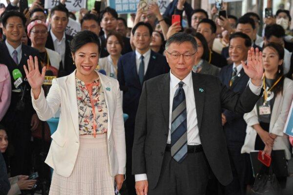 Presidential candidate Ko Wen-je (R), chairman of the Taiwan People's Party (TPP), and running mate Cynthia Wu wave after they registered for the upcoming 2024 presidential elections at the Central Elections Commission in Taipei, Taiwan, on Nov. 24, 2023. (Sam Yeh/AFP via Getty Images)