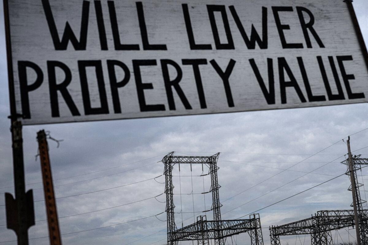 An electrical substation and a solar protest sign are seen near the property of Lance Martin, who is opposed to commercial solar farms, in New Bloomfield, Miss., on March 15, 2023. (Brendan Smialowski/AFP via Getty Images)