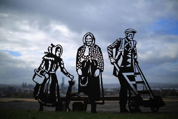 A new portrait bench celebrating three local icons Kitty Wilkinson, Molly Bushell and a dock worker overlooks the city of Liverpool from Everton Park, in Liverpool, England, on Oct. 18, 2012. (Christopher Furlong/Getty Images)