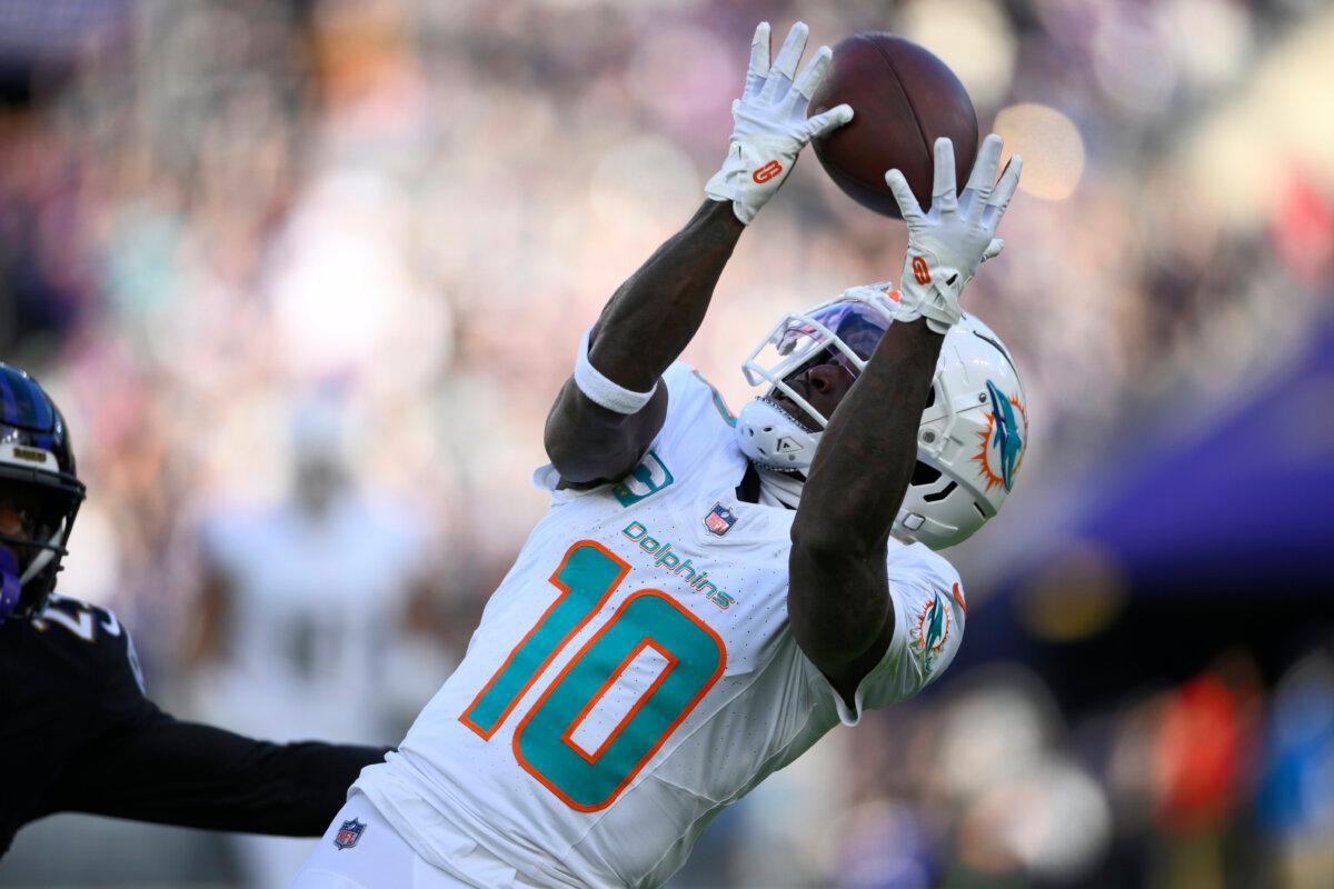 Miami Dolphins wide receiver Tyreek Hill (10) catches a pass for a first down against the Baltimore Ravens during the first half of an NFL football game in Baltimore, on Dec. 31, 2023. (Nick Wass/AP Photo)
