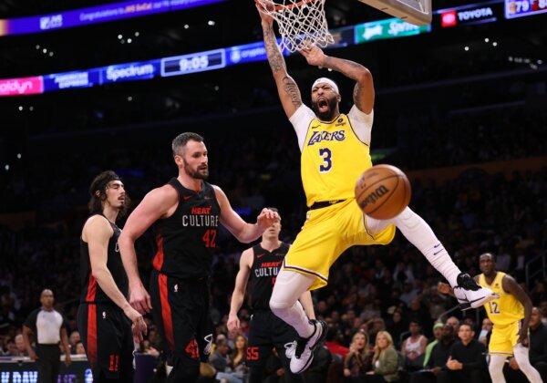 Anthony Davis (3) of the Los Angeles Lakers reacts to his dunk in front of Kevin Love (42) and Jaime Jaquez Jr. (11) of the Miami Heat during a Heat win in Los Angeles on Jan. 3, 2024. (Harry How/Getty Images)