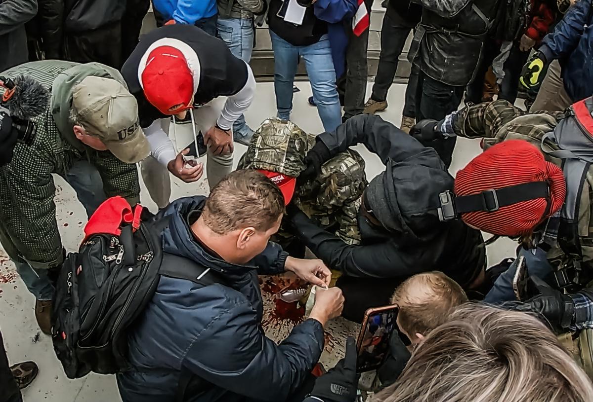 Bystanders try to stop the profuse bleeding from the face of Joshua Black, who was shot in the face by Capitol Police on Jan. 6, 2021. (Special to The Epoch Times)