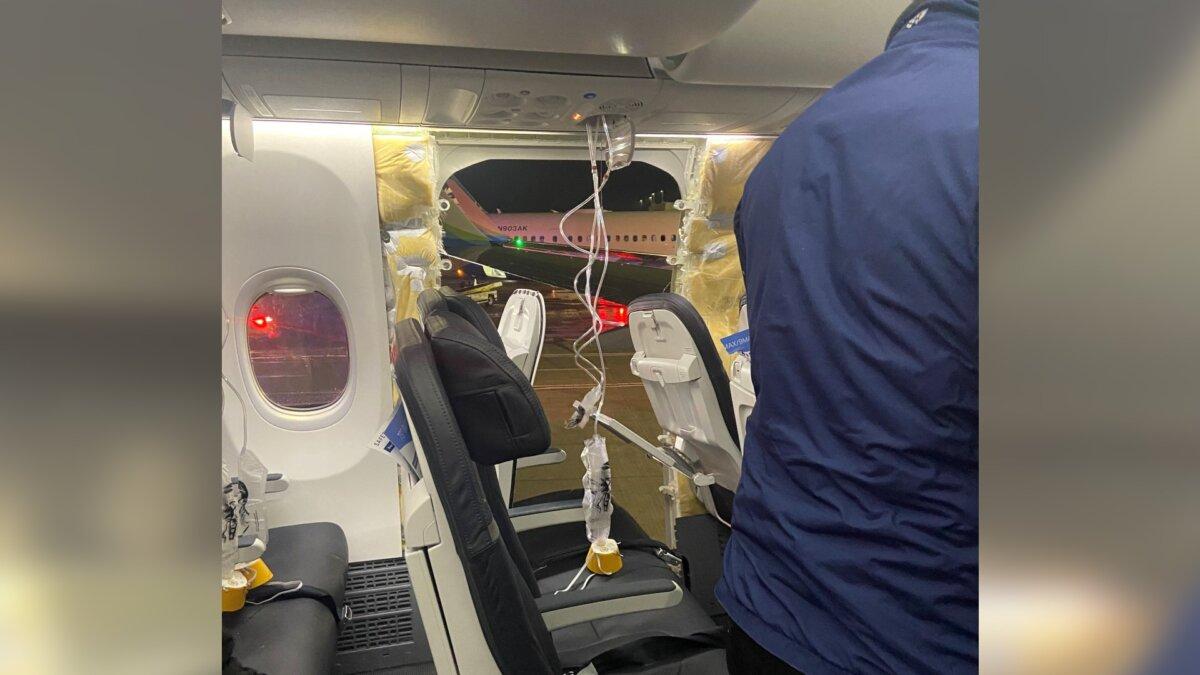 Passenger oxygen masks hang from the roof next to a missing window and a portion of a side wall of an Alaska Airlines Flight 1282, which had been bound for Ontario, California and suffered depressurization in Portland, Ore., on Jan. 5, 2024, in this picture obtained from social media. (Kyle Rinker via Reuters)