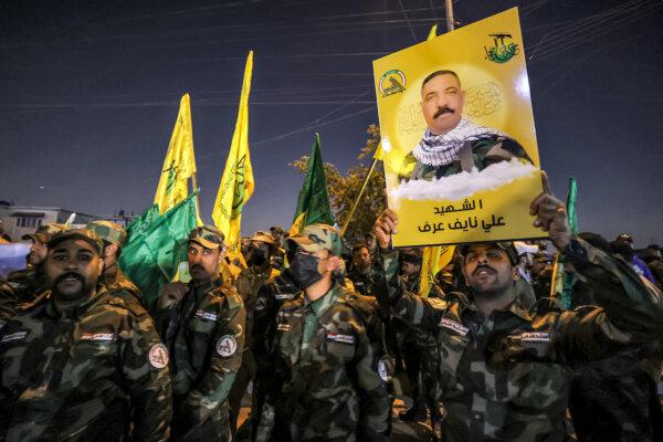 Iraq’s Popular Mobilization Forces (PMF) display a sign identifying one of its members killed in a US strike in Baghdad, on January 4, 2024. (Ahmad Al-Rubaye/AFP via Getty Images)