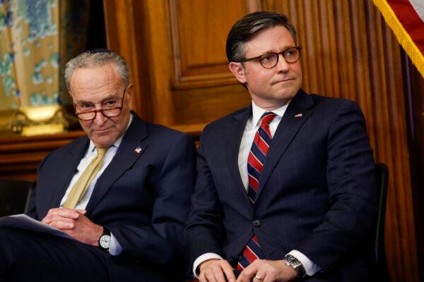 Senate Majority Leader Chuck Schumer (D-N.Y.) and House Speaker Mike Johnson (R-La.) listen to remarks at a Capitol Menorah lighting ceremony at the U.S. Capitol Building in Washington on Dec. 12, 2023. (Anna Moneymaker/Getty Images)
