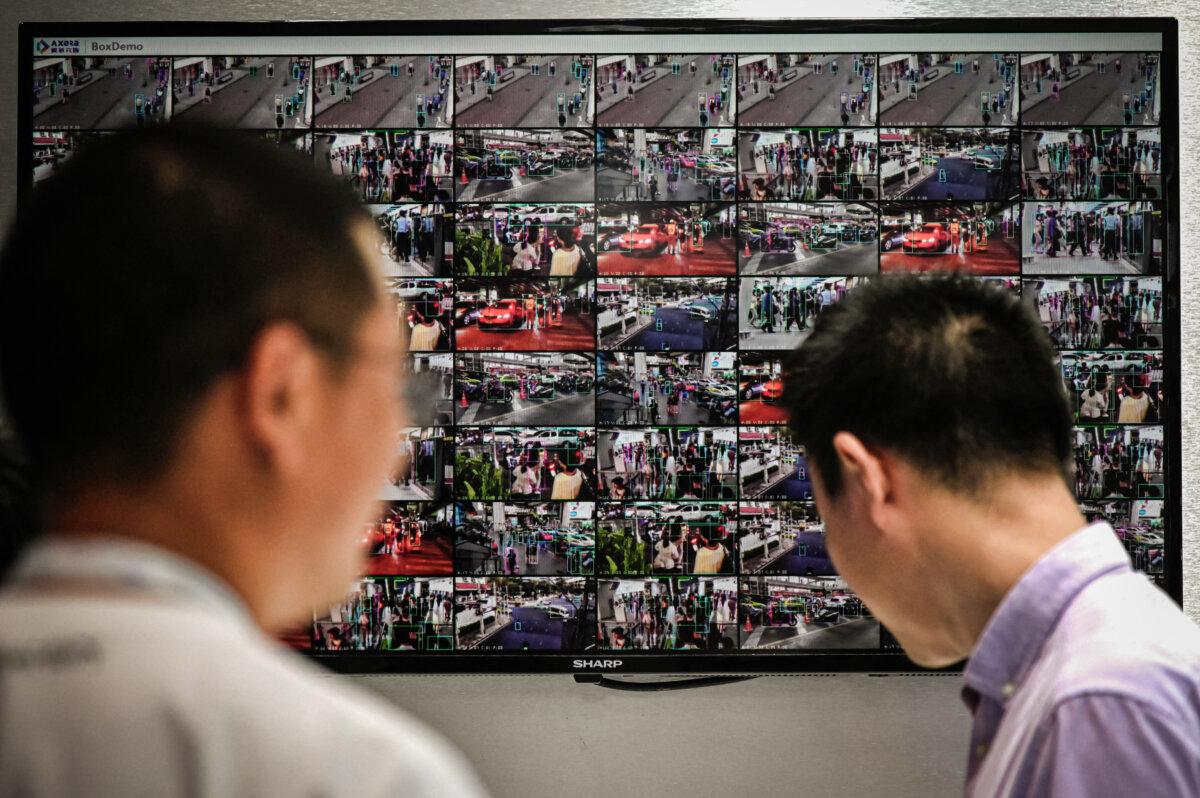 People are seen on screens from closed circuit television security cameras at the World Artificial Intelligence Conference in Shanghai, China, on July 6, 2023. (Wang Zhao/AFP via Getty Images)