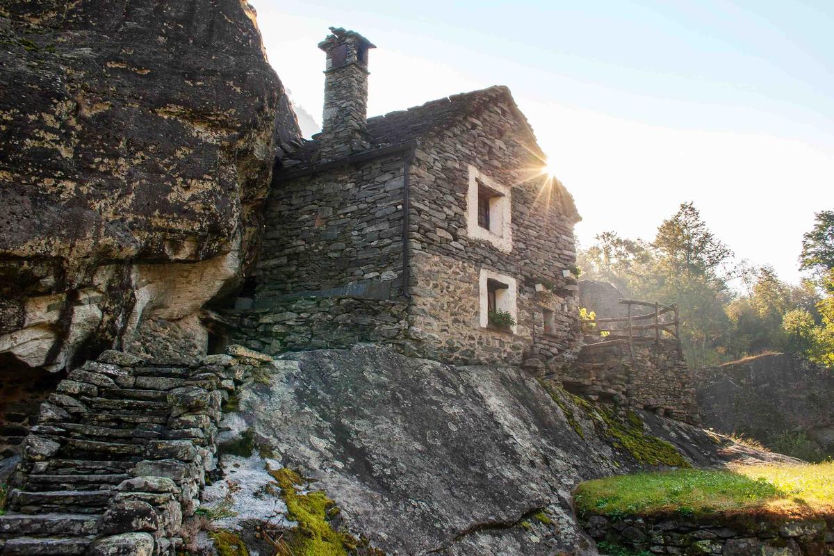 A home built beside a massive boulder in Bavona Valley. (dosmass/Shutterstock)
