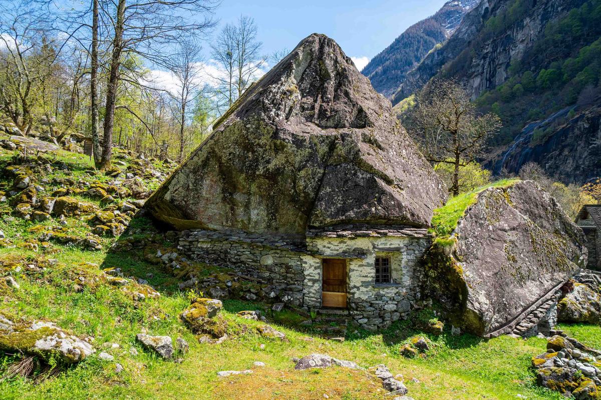 A house built under a monolithic boulder. (DjemoGraphic/Shutterstock)