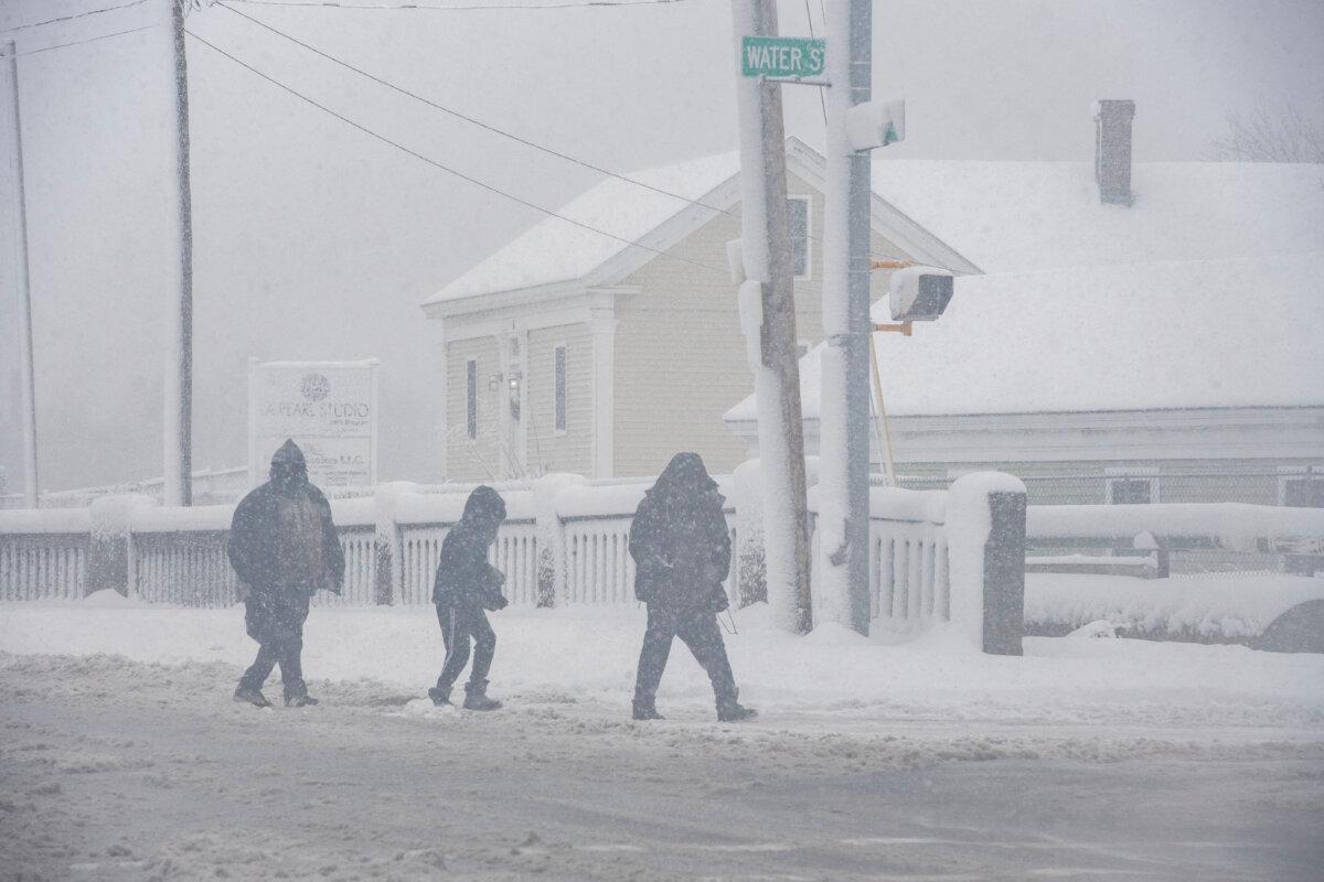 People walk through the snowstorm in Lawrence, Mass., on Jan. 7, 2024. (Joseph Prezioso/AFP via Getty Images)