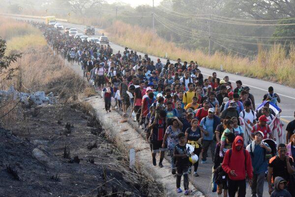 Migrants walk along the highway through Arriaga, Chiapas state in southern Mexico on Jan. 8, 2024, during their journey north toward the U.S. border. (Edgar H. Clemente/AP Photo)