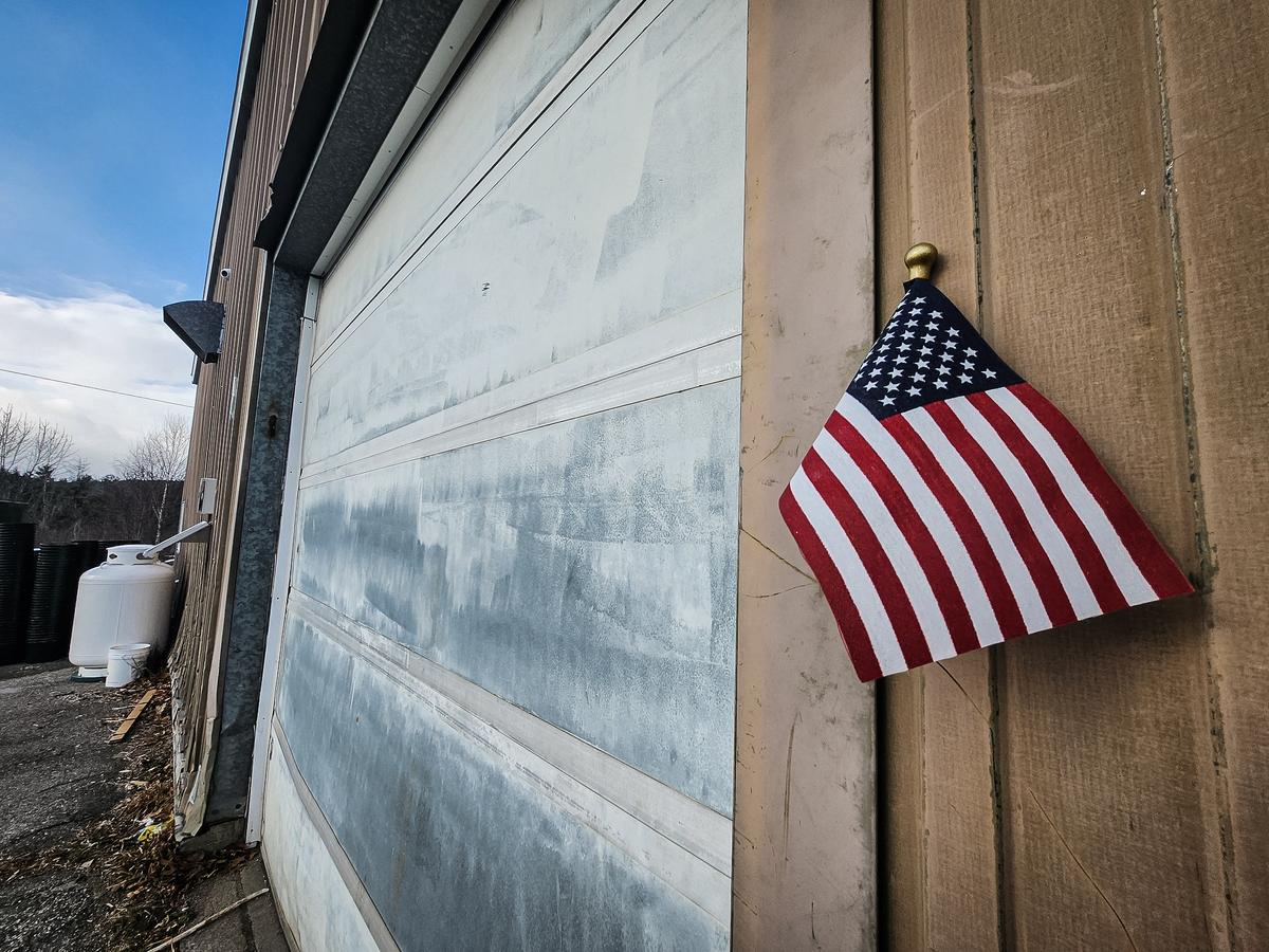 A small flag hangs outside the industrial building in Wilton, Maine, where police found an illegal marijuana cultivation operation by suspected Chinese foreign nationals. (Allan. Stein/The Epoch Times)