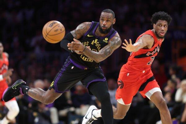 LeBron James (23) of the Los Angeles Lakers passes the ball as Thaddeus Young (21) of the Toronto Raptors defends during the first half of a game in Los Angeles on Jan. 9, 2024. (Sean M. Haffey/Getty Images)