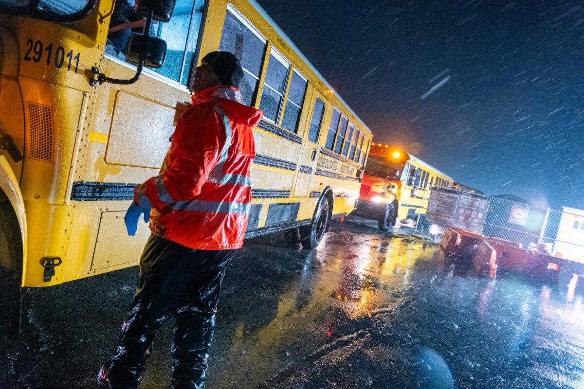 Nearly 2,000 illegal immigrants are evacuated by school buses from tents at Floyd Bennett Field to a local high school in preparation for a storm with estimated wind speeds of more than 70 mph. in the Brooklyn borough of New York City, on Jan. 9, 2024. (Spencer Platt/Getty Images)
