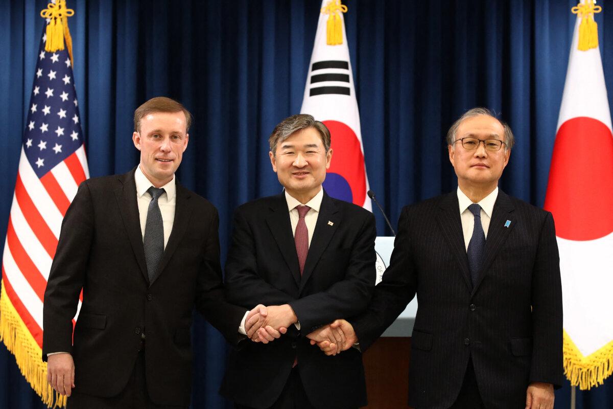 South Korea's National Security Adviser Cho Tae-yong (C) shakes hands with U.S. National Security Advisor Jake Sullivan (L) and Japan's National Security Secretariat Secretary-General Takeo Akiba (R) after their joint press conference at the presidential office in Seoul on Dec. 9, 2023. (Chung Sungjun /POOL/AFP via Getty Images)