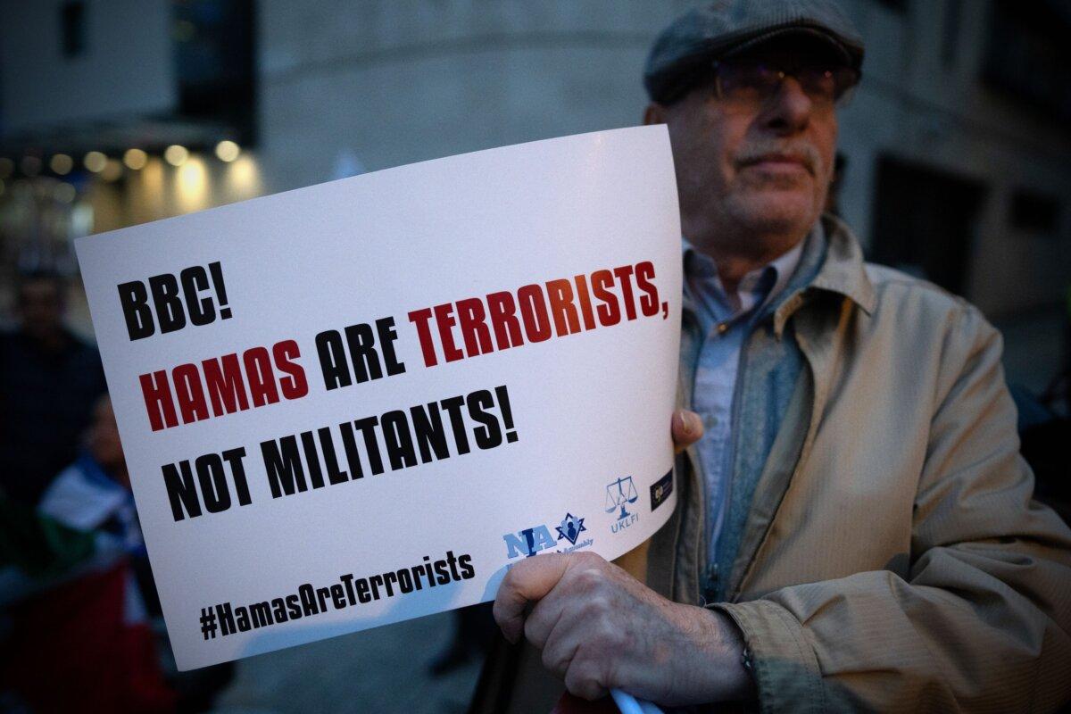 A member of the Jewish community holds a poster outside BBC Broadcasting House to demonstrate against the BBC's refusal to label Hamas as terrorists, in London, England, on Oct. 16, 2023. (Carl Court/Getty Images)