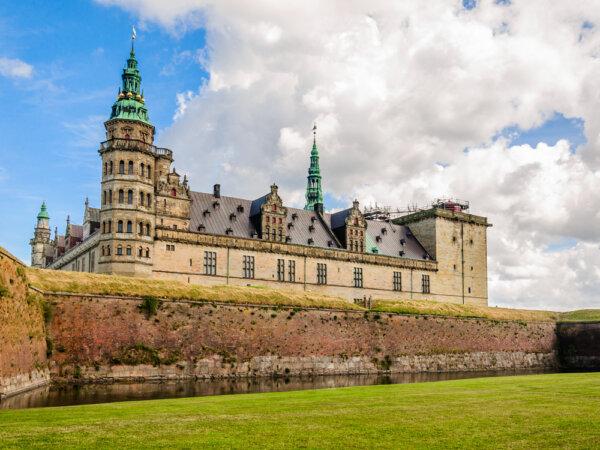 Known as Elsinore Castle from Shakespeare’s “Hamlet,” Kronborg Castle has traces of the original architecture within the castle’s immense fortifications. Brick walls and a moat surround the white sandstone structure with irregular window axes and topped by Baroque green-copper spires. (Andrey Shcherbukhin/Shutterstock)