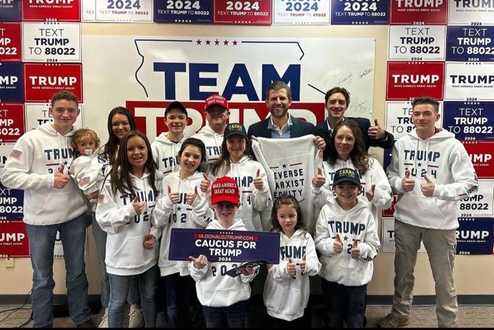 Members of the Krachenfels family of West Des Moines, Iowa, pose with Eric Trump, center rear, at a campaign headquarters for former President Donald Trump's 2024 presidential run in Urbandale, Iowa, on Jan. 4, 2024. (Courtesy of Tim Krachenfels)