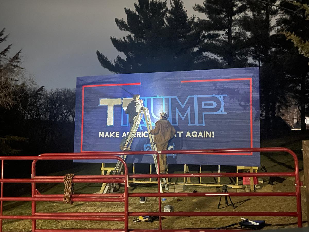 Members of the Krachenfels family work on a large sign they created to proclaim support for former President Donald Trump at their home in West Des Moines, Iowa. (Courtesy of Tim Krachenfels)