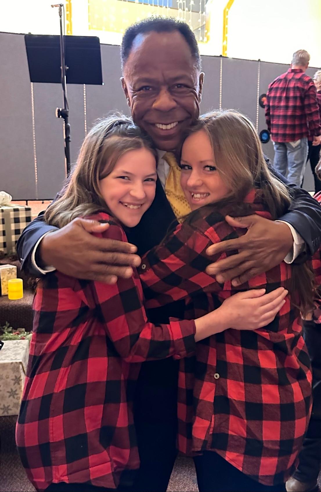 Leo Terrell, a Democrat who became a supporter of former President Donald Trump, a Republican, poses with Isabelah Krachenfels, 13, (L) and her sister, Alaycia, 16, at their church, Soteria Des Moines, on Dec. 10, 2023. (Courtesy of Leo Terrell)