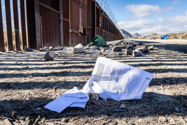Discarded paperwork sits near the United States border wall in Jacumba, Calif., on Jan. 10, 2024. (John Fredricks/The Epoch Times)