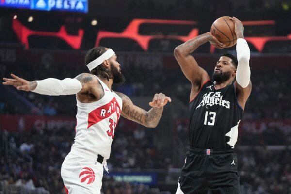Los Angeles Clippers forward Paul George (R) shoots as Toronto Raptors guard Gary Trent Jr. defends during the first half of an NBA basketball game in Los Angeles on Jan. 10, 2024. (Mark J. Terrill/AP Photo)