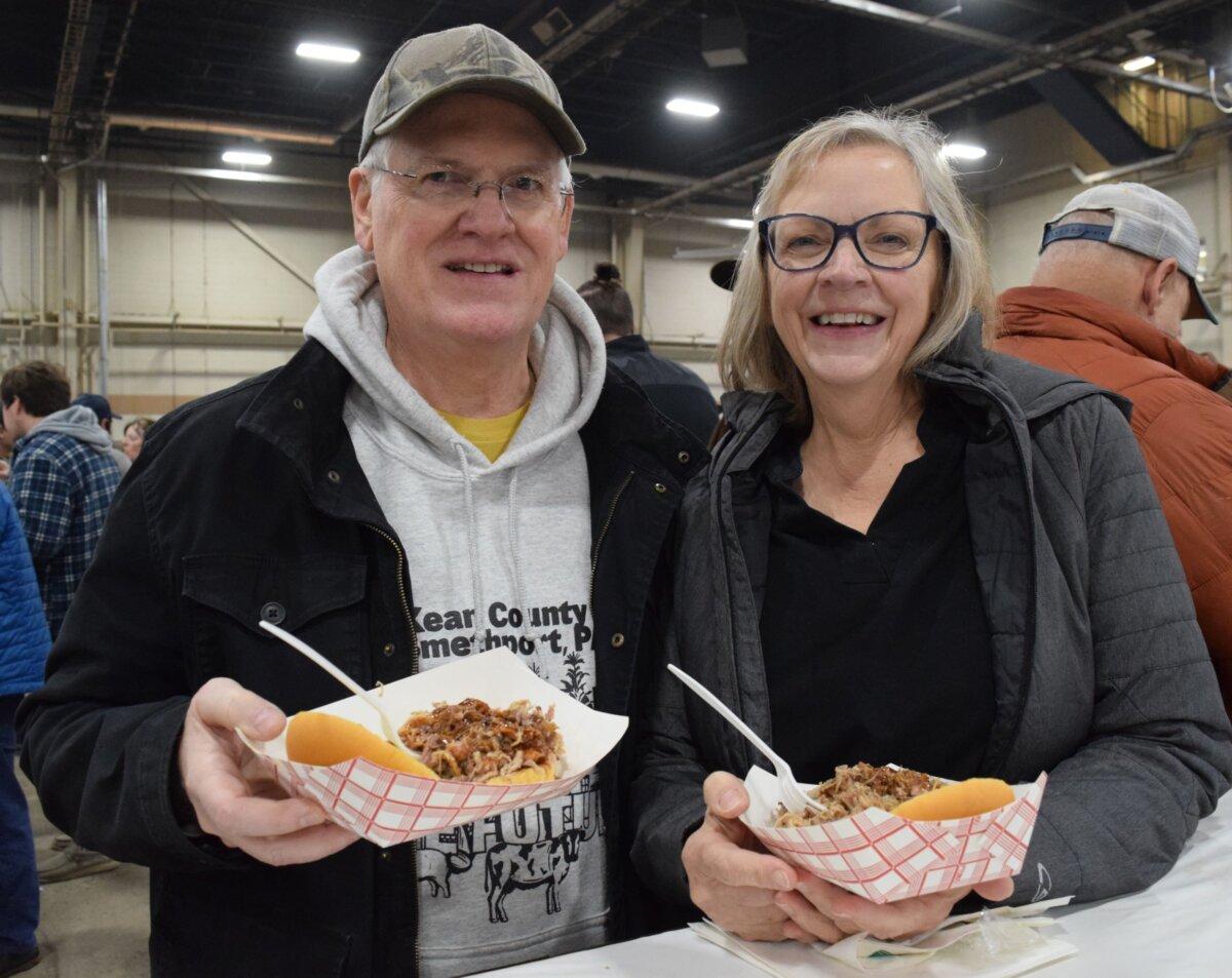 Gene and Crystal Jones enjoy pulled pork sandwiches at the Pennsylvania Farm Show in Harrisburg, Penn., on Jan. 11, 2024. (Beth Brelje/The Epoch Times)
