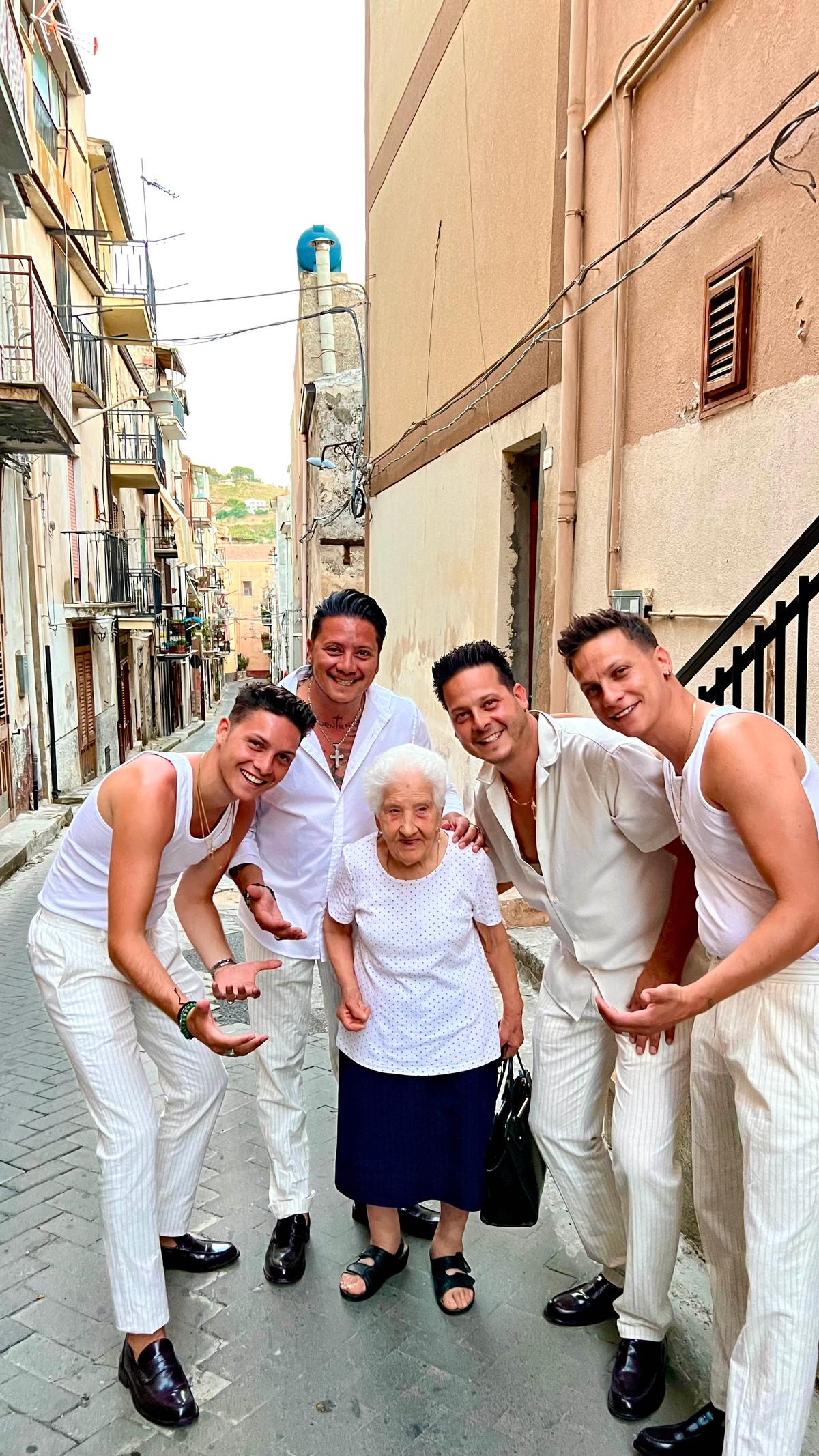 "The Esteriore Brothers" with Rosa. They say the elderly lady's enduring presence has been a constant source of "joy and<br/>inspiration" for them. (Courtesy of The Esteriore Brothers)