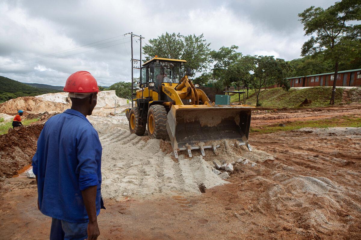 A foreman looks on as a bulldozer works on the slippery road at Arcadia lithium mine on Jan. 11, 2022, in Goromonzi, Zimbabwe. (Tafadzwa Ufumeli/Getty Images)